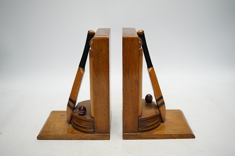 A pair of oak cricket 'bat, ball and stumps' book ends, handmade by Thornton Smith Company, c.1930, 18cm high. Condition - good